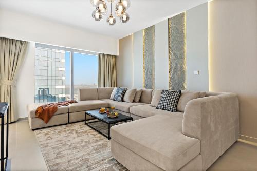 a living room with a couch and a table at Desert Key - Platinum Apartments in Gate Tower, Al Reem Island in Abu Dhabi