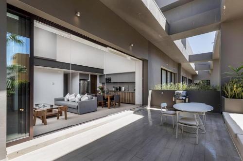 a living room with a couch and a table at Cabo Marina 3 BR Loft Walk to Medano Beach in Cabo San Lucas