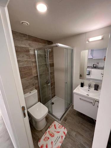 a bathroom with a toilet and a shower and a sink at Studio sea view in Boğaz