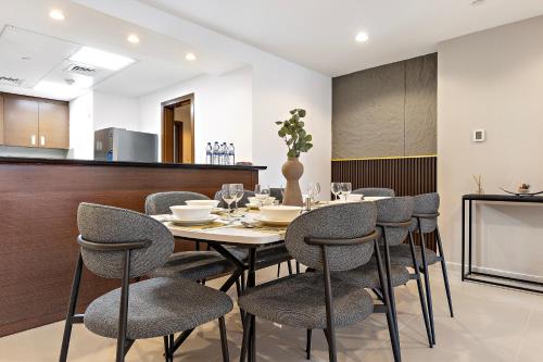 a dining room with a table and chairs at Desert Key - Platinum Apartments in Gate Tower, Al Reem Island in Abu Dhabi