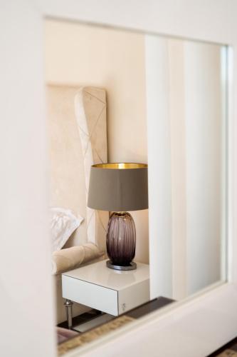 a lamp sitting on a table in a living room at Argaka Luxury Residence in Paphos City