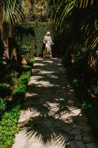 a statue of a woman walking down a path at Argaka Luxury Residence in Paphos City