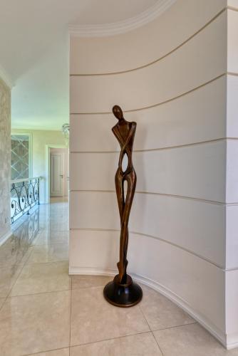 a statue in a room with a wall at Argaka Luxury Residence in Paphos City