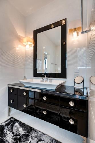 a bathroom with a sink and a mirror at Argaka Luxury Residence in Paphos City