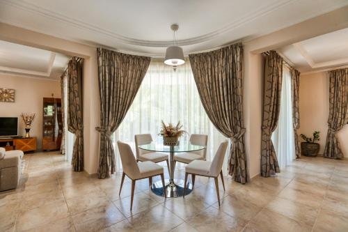 a dining room with a table and chairs at Argaka Luxury Residence in Paphos City