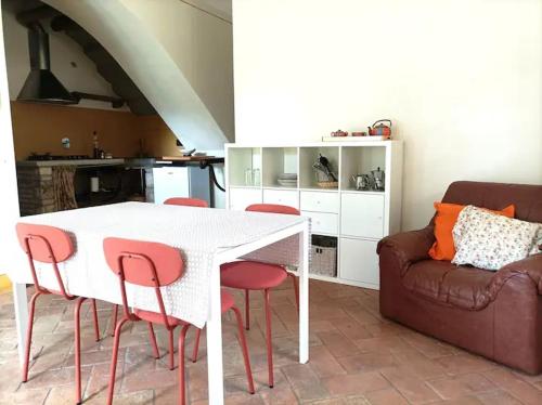 a living room with a white table and a couch at Home in Tuscany in Greve in Chianti