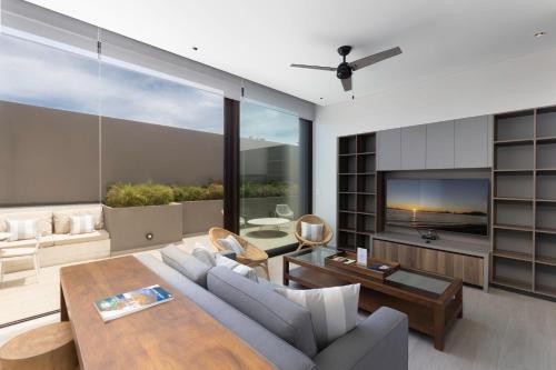 a living room with a couch and a table at Best Location in Cabo Marina Private Rooftop Sleeps 8 in Cabo San Lucas