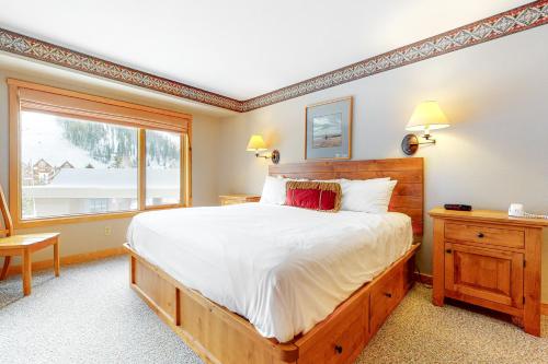 a bedroom with a large bed and a window at Shoshone 1909 in Big Sky