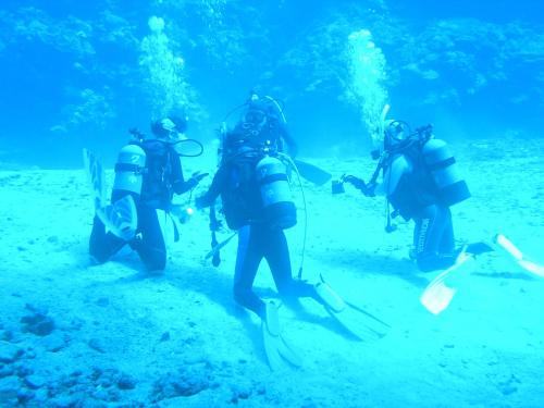 a group of people in the water with scooters at Cypress Resort Kumejima in Kumejima