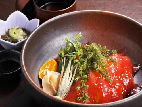 a bowl of food with vegetables and sauce at Cypress Resort Kumejima in Kumejima