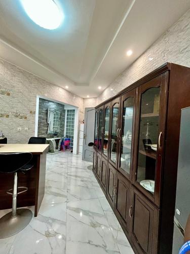 a room with a large wooden cabinet with glass doors at Pearl Haven Suite - Appartement F2 bord de mer in Dakar
