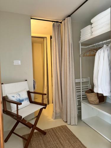 a room with a chair and a closet at Blue Krk With Private Garden in Krk