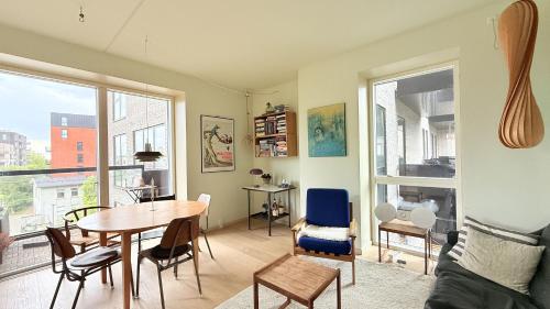 a living room with a table and chairs at ApartmentInCopenhagen Apartment 1634 in Copenhagen
