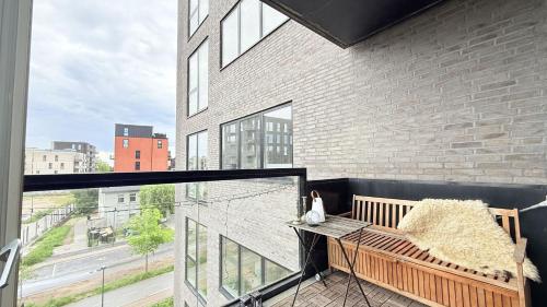 a balcony with a bench and a large window at ApartmentInCopenhagen Apartment 1634 in Copenhagen