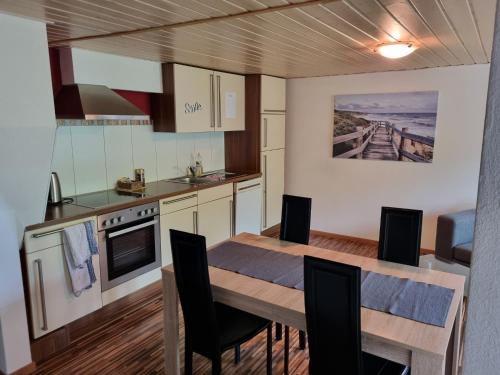 a kitchen and dining room with a table and chairs at Studio im Grünen in Schänis