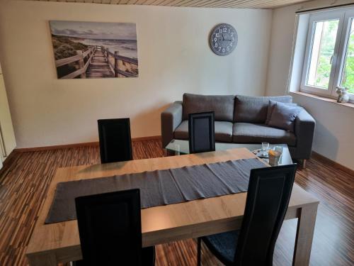 a living room with a table and a couch at Studio im Grünen in Schänis