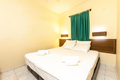 a bedroom with a large bed with a green curtain at The Aegean Gate Hotel in Bodrum City