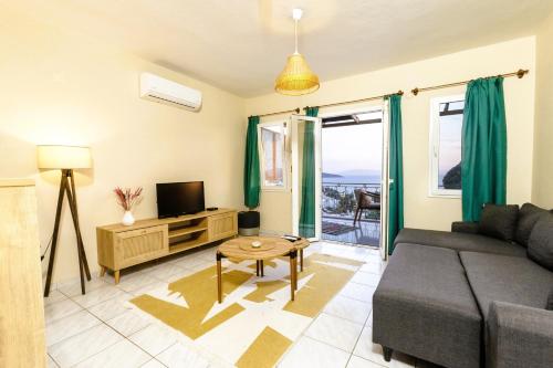 a living room with a couch and a tv at The Aegean Gate Hotel in Bodrum City