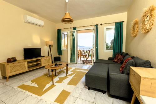 a living room with a couch and a tv at The Aegean Gate Hotel in Bodrum City