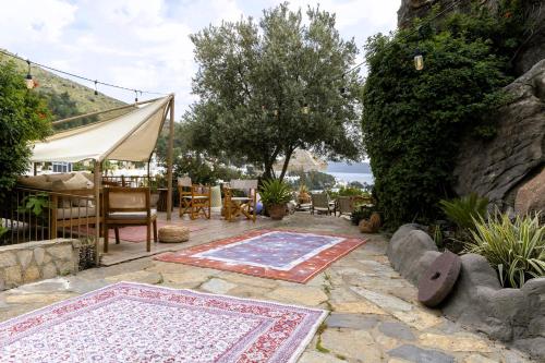 a patio with two rugs and a table and chairs at The Aegean Gate Hotel in Bodrum City