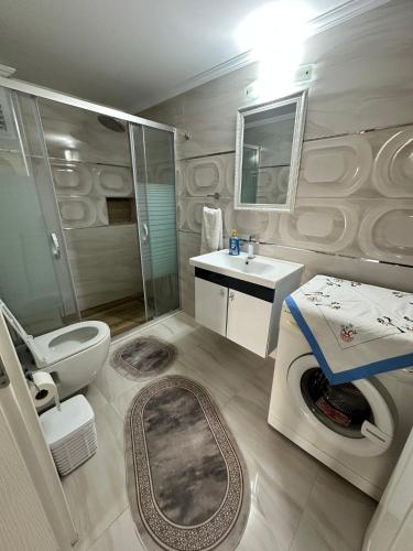 a bathroom with a toilet and a sink and a shower at Villa huzur in Marmaris