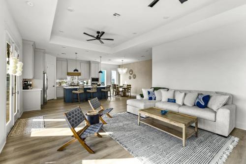 a living room with a couch and a table at Beach Access Games Firepit Brand New in Bolivar Peninsula