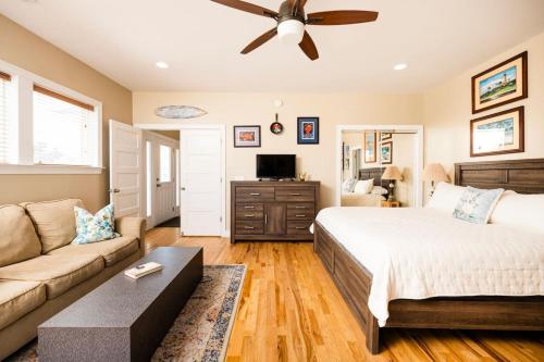 a bedroom with a bed and a couch at Paws. . . and RELAX. A PF getaway in the clouds in Carolina Beach