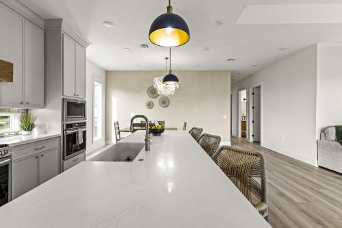 a kitchen with a large white counter top in a room at Beach Access Games Firepit Brand New in Bolivar Peninsula