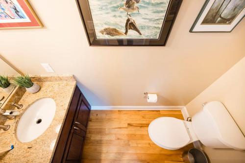 a bathroom with a toilet and a sink at Paws. . . and RELAX. A PF getaway in the clouds in Carolina Beach