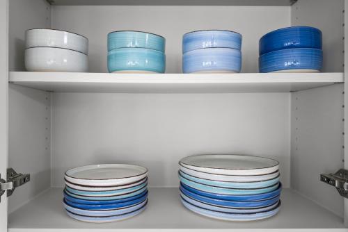 a shelf filled with blue and white plates at Beach Access Games Firepit Brand New in Bolivar Peninsula