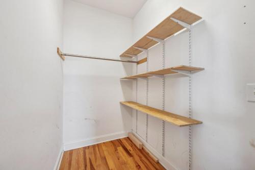 a walk in closet with white walls and wooden shelves at Paws. . . and RELAX. A PF getaway in the clouds in Carolina Beach
