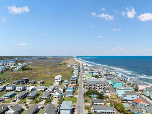 an aerial view of a beach with houses and the ocean at Paws. . . and RELAX. A PF getaway in the clouds in Carolina Beach