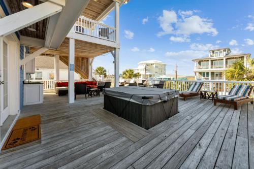 a large deck with a hot tub on a house at Paws. . . and RELAX. A PF getaway in the clouds in Carolina Beach