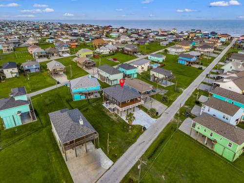 an aerial view of a neighborhood with houses and the ocean at Beach Access Games Firepit Brand New in Bolivar Peninsula