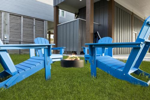 two blue chairs and a fire pit in a yard at Beach Access Games Firepit Brand New in Bolivar Peninsula