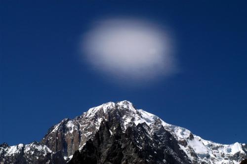 a snow covered mountain with the moon in the sky at Hotel Beau Sejour Pré-Saint-Didier in Pré-Saint-Didier