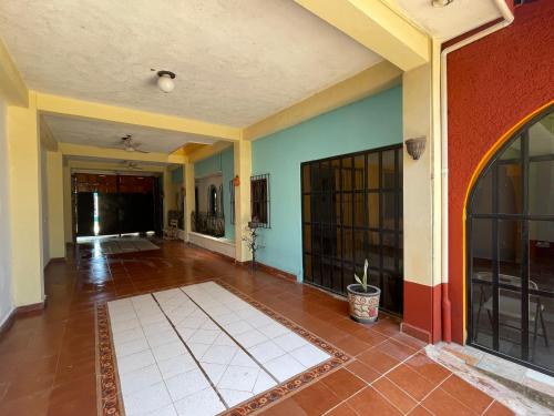 an empty room with colorful walls and a tile floor at La casa de la abuela in Palenque