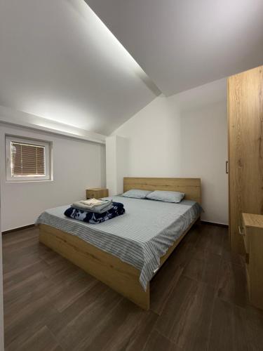 a bedroom with a large bed in a room at Restaurant & Apartments Lipa in Peštani