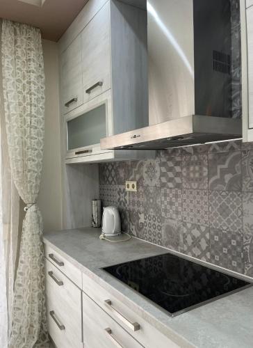 a kitchen with white cabinets and a counter top at Alba House in Prinos