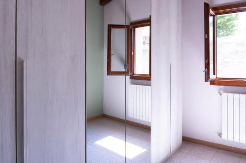 a glass shower in a room with a window at Casa Il Nocciolo in Rocca Malatina