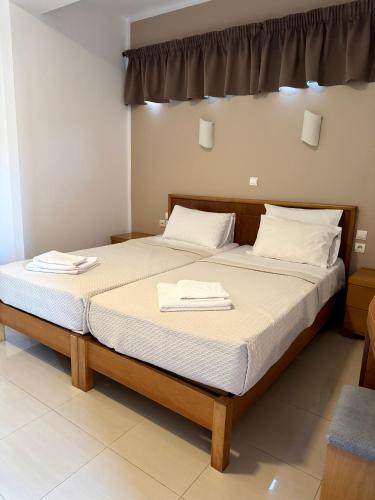 a bedroom with two beds with towels on them at Pachia Ammos Falasarna in Falasarna