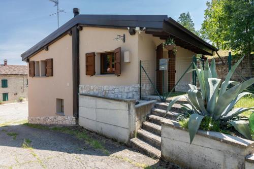 a small house with stairs leading up to it at Casa Il Nocciolo in Rocca Malatina