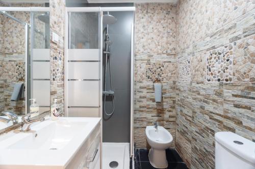 een badkamer met een wastafel, een toilet en een douche bij Casa do Pereira in Lissabon