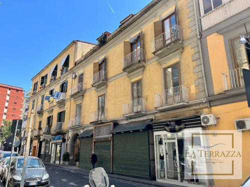 a building on a city street with a store at La Terrazza in Castellammare di Stabia
