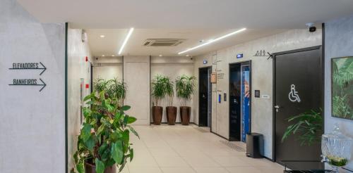 an office hallway with potted plants on the walls at ibis Sao Luis in São Luís