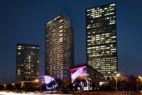 two tall buildings in a city at night at Kerry Hotel Pudong, Shanghai - Indoor Connecting to Shanghai New International Expo Centre in Shanghai
