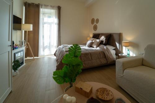 a living room with a bed and a couch at San Carlo Apartments B&B Caserta in Caserta
