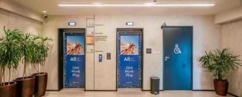 a lobby with two blue doors in a building at ibis Sao Luis in São Luís