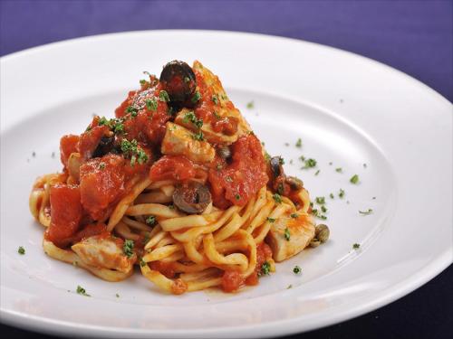 a plate of pasta on a white plate at Cypress Resort Kumejima in Kumejima