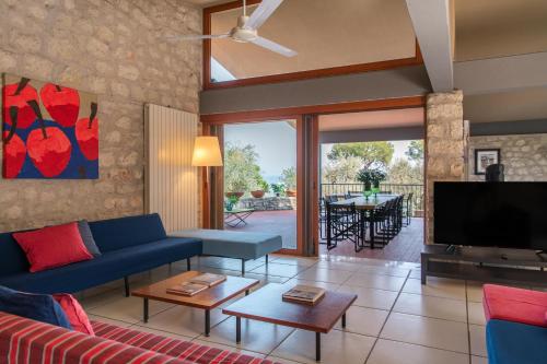 a living room with a blue couch and a tv at Villa Elena in Manerba del Garda